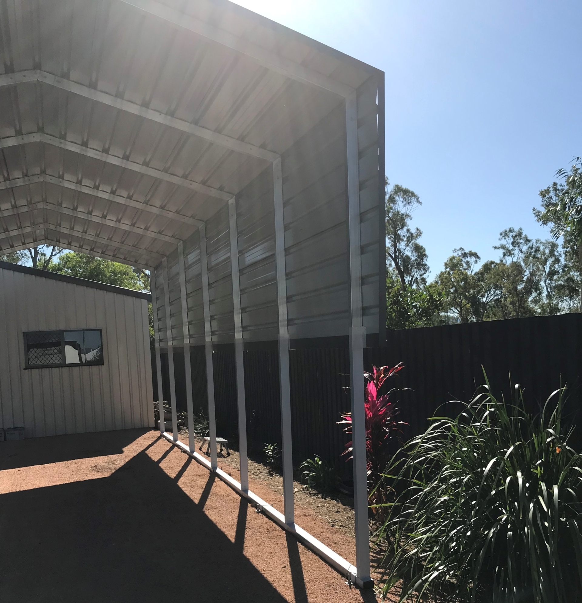 Partial view of a backyard shade shelter.