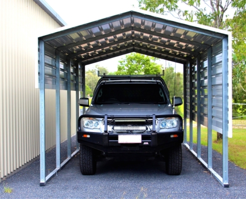 A ute parked under a car shelter.