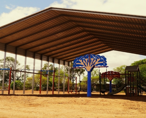 An industrial size shade shed over a playground.