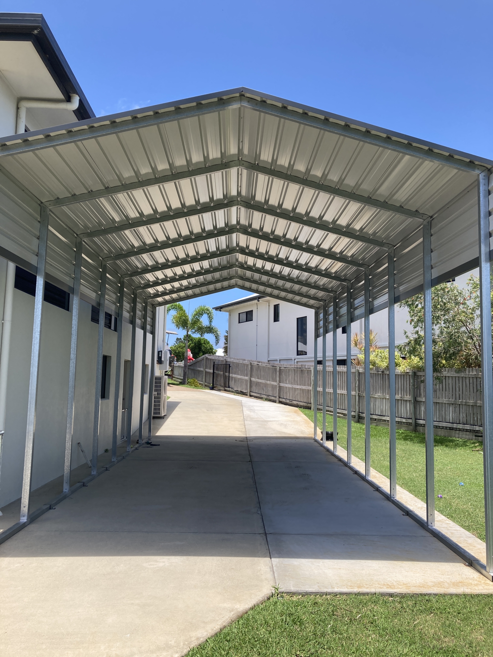 a metal covered garage with a roof