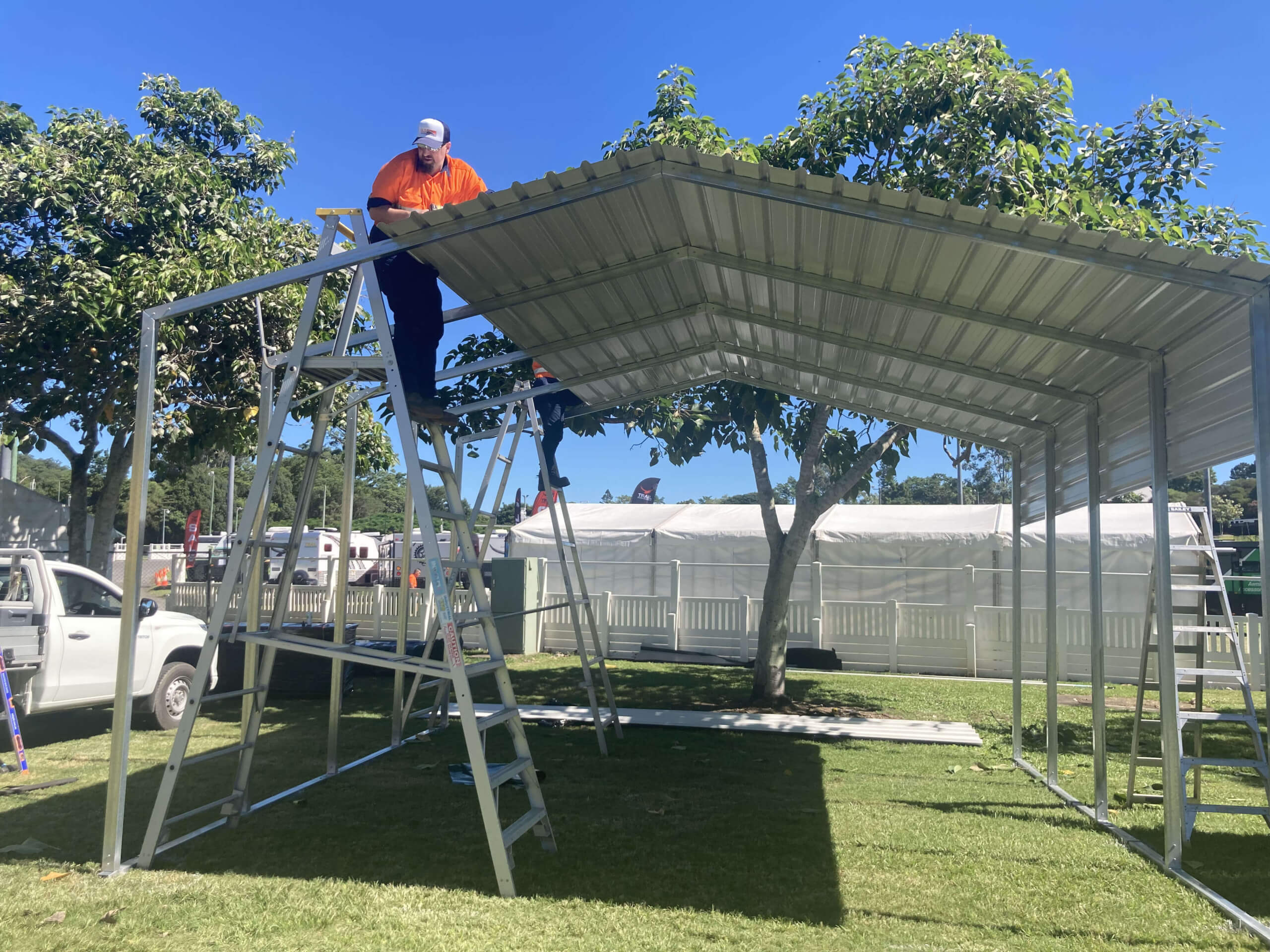 a man on a ladder on a metal structure