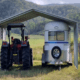 a tractor parked under a shed