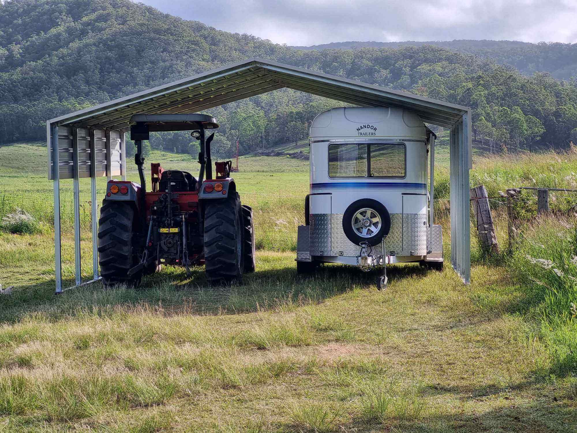 a tractor parked under a shed