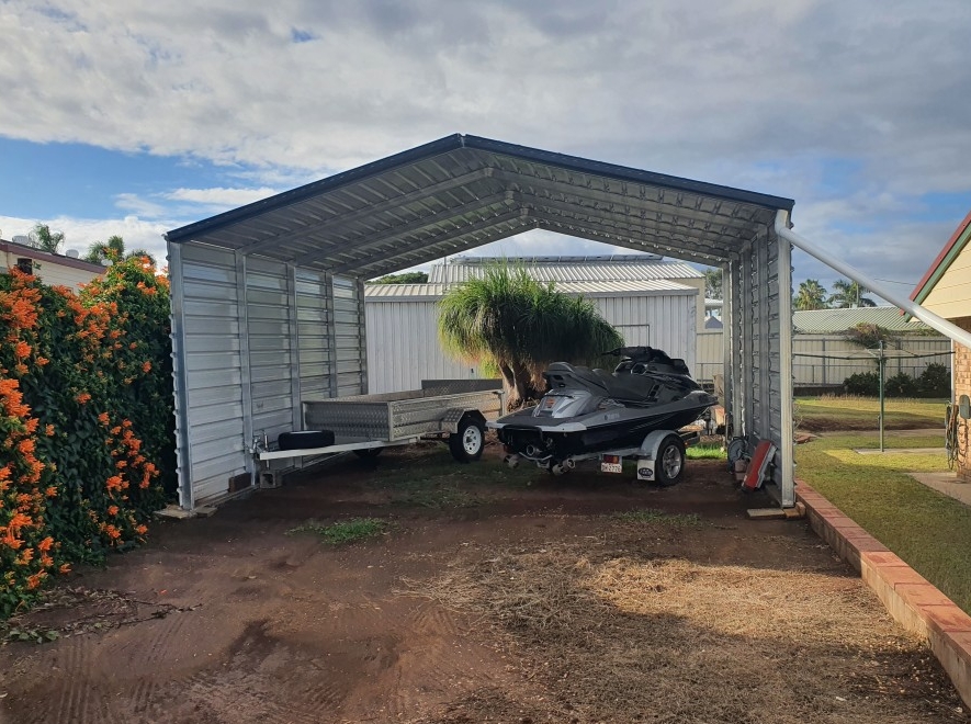 a boat and trailer under a shed