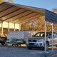 a car and trailer parked under a shade shed shelter